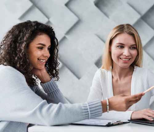 A couple of female students are discussing the course.